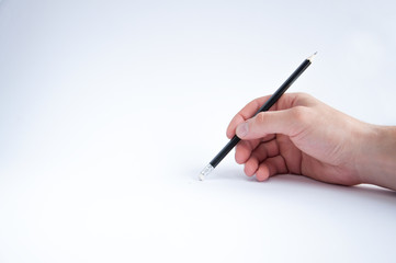 black pencil holds in his right hand. draws on a white background