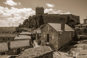Old houses on alley and castle on top of cliff