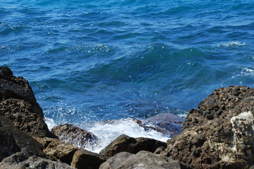 Beautiful blue sea and playful waves under the blue sky