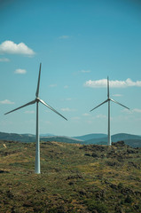 Wind turbines over hilly landscape