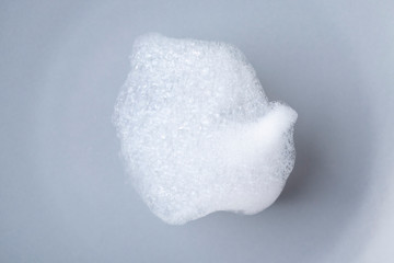 A piece of foam on a gray ceramic plate