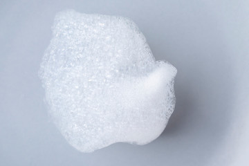 A piece of foam on a gray ceramic plate