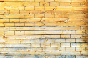 Wood plank texture with brick cutouts. Wooden brick yellow. Background tree structure brick.