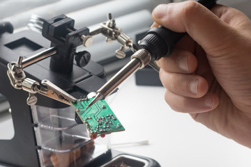Electronics engineer repaired with soldering using soldering station and other components