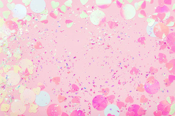 Colorful Confetti and sparkles on pink pastel trendy background. Festive frame, holiday backdrop....