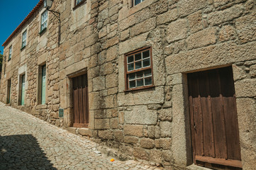House made of stone with wooden door in an alley