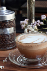 cup of coffee with cream and flowers