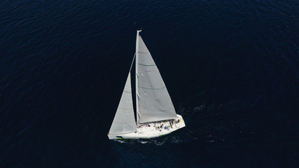Aerial drone photo of sail boat cruising the deep blue Aegean sea, Greece