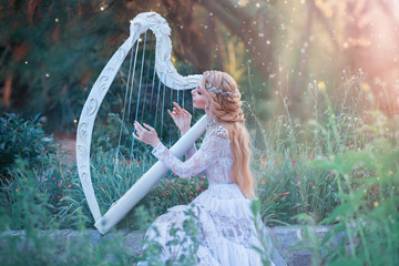 mysterious forest nymph plays on white harp in fabulous place, girl with long blond hair and...