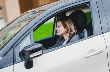 Woman millennial happy drive a car