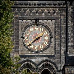 decorated church clock with red, blue and golden color