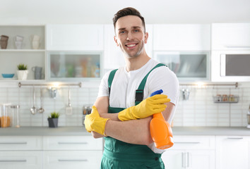 Portrait of janitor with sprayer in kitchen. Cleaning service