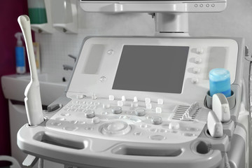 Fototapeta na wymiar Modern ultrasound machine in clinic, space for text