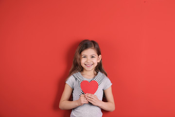 Portrait of girl with paper heart on color background
