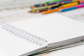 Bright multi-colored pencils and one album for drawing are on the table.