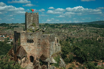 Stone castle and tower over rocky cliff