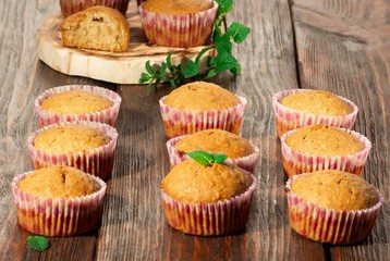 Vanilla cupcake, homemade pastry on wooden background