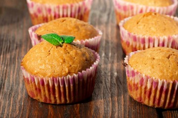 Vanilla cupcake, homemade pastry on wooden background
