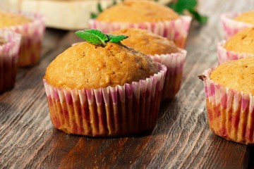 Vanilla cupcake, homemade pastry on wooden background