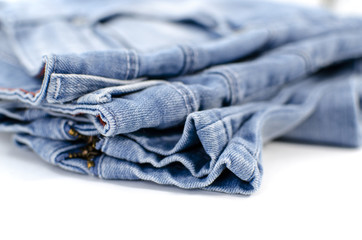 Blue jeans is on a white background. Clothes for donations. Fragments of clothing.