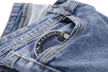 Blue jeans is on a white background. Clothes for donations. Fragments of clothing.