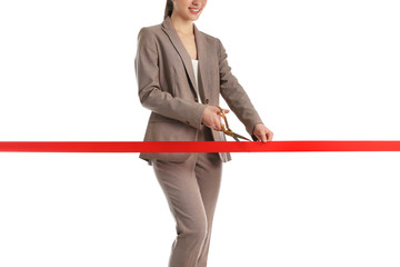 Woman in office suit cutting red ribbon isolated on white, closeup