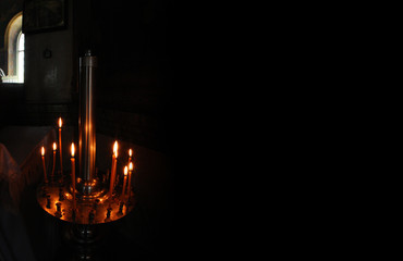 Candle light in dark in Christianity church.