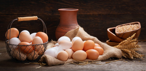 still life with fresh eggs, grains and wheat ears