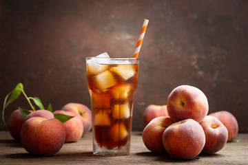 glass of peach iced tea with fresh fruits