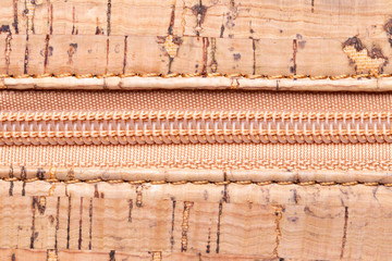 Close up of zipper. A high-resolution closeup of a detail from a closed zipper on a handbag made of natural cork. Macro photo.