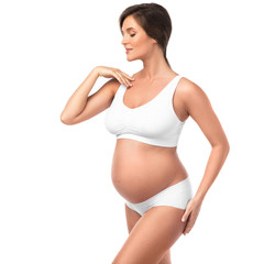 Fototapeta premium Young and beautiful pregnant woman on white background