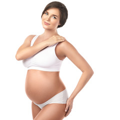 Fototapeta premium Young and beautiful pregnant woman on white background
