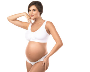 Young and beautiful pregnant woman on white background