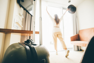 Women staying near the window in a hotel room. Open the curtain and having a fun. Concept of...