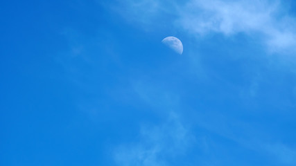 moon on a blue sky day