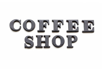 The inscription COFFEESHOP. COFFEESHOP in black bulk letters on a white background. Photo of the lettering, close-up