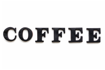 The inscription COFFEE. COFFEE in black bulk letters on a white background. Photo of the lettering, close-up