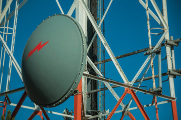 Transmission antenna dish in a tower and blue sky