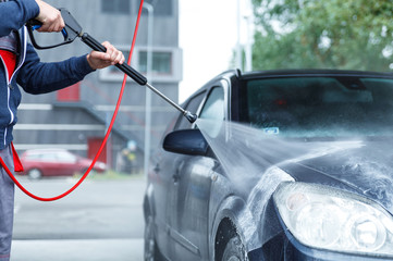 Car wash worker is washing client's car