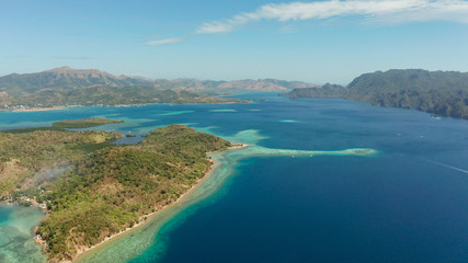 Fototapeta na wymiar aerial view tropical islands with blue lagoons, coral reef and sandy beach. Palawan, Philippines. Island Busuanga of the Malayan archipelago with turquoise lagoons.