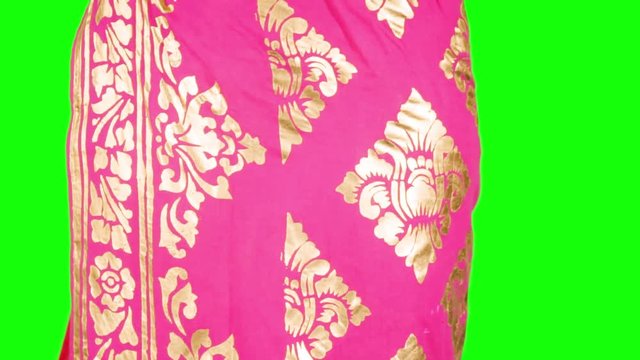 Pretty balinese dancer with traditional clothes smiling at the camera in the studio. Shot in 4k resolution with green screen background