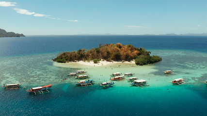 aerial view tropical island with sand white beach, clear and blue water. CYC Beach, Philippines, Palawan. Tropical landscape with blue lagoon, coral reef. travel concept