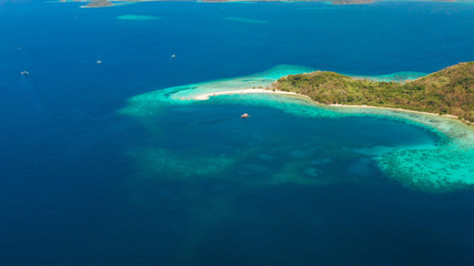 Aerial view tropical beach on island Ditaytayan. tropical island with white sand bar, palm trees and green hills. Travel tropical concept. Palawan, Philippines