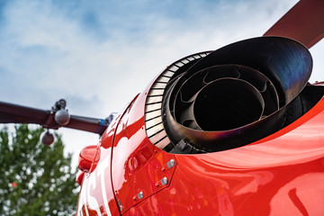 Rear view of an red helicopter with exhaust
