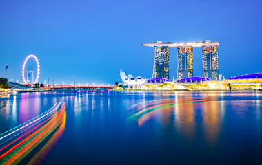 SINGAPORE, SINGAPORE - MARCH 2019: Skyline of Singapore Marina Bay at night with Marina Bay sands, Art Science museum and tourist boats