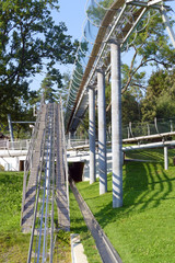 Curved bobsleigh track ramp with protective cage