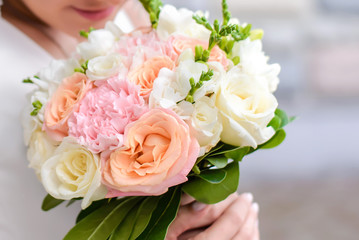 Wedding bouquet in the hands of the bride