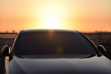 Fototapeta na wymiar top of luxury car on sunset background