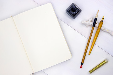 Sketchbook blank page. Notebook top view photo on white background. Minimal flat lay with drawing...