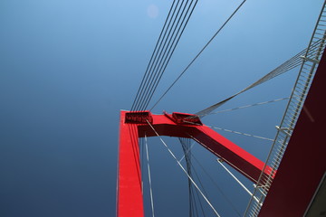 Fototapeta premium Red colored Willemsbrug over river Nieuwe Maas in Rotterdam, the Netherlands